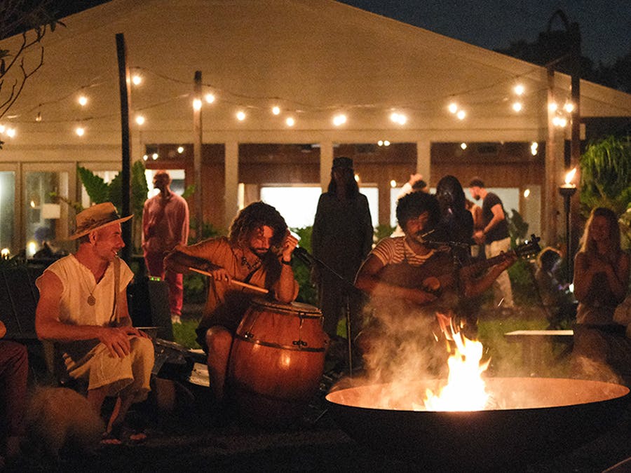People playing music around a fire pit